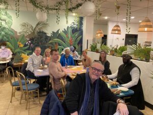 People sitting around a table smiling at the camera.